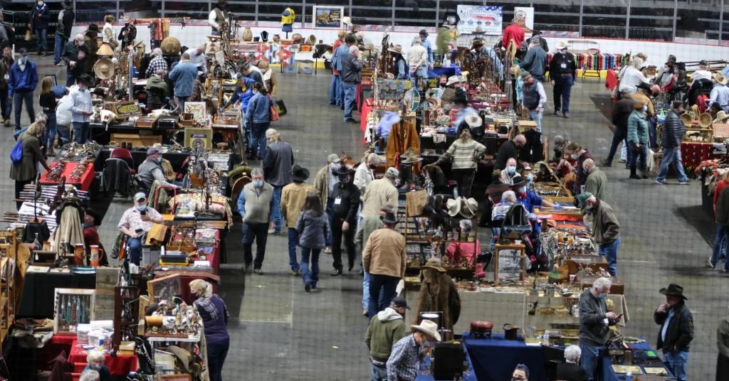 Overhead view of the packed CCG 2021 show floor with hundreds of collectors browsing vendor booths, many wearing masks