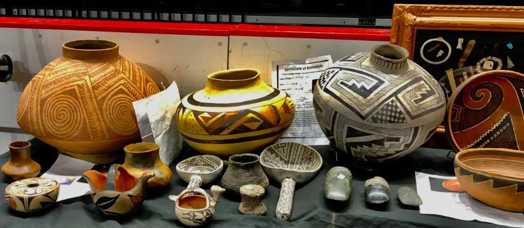 Collection of Native American pottery including large geometric-patterned vessels with certificates of authenticity