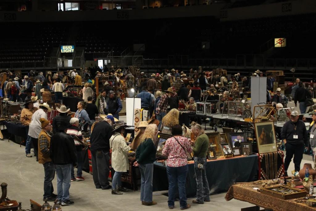 Wide view of the packed CCG show floor with hundreds of collectors browsing vendor booths under the Bud Light arena sign