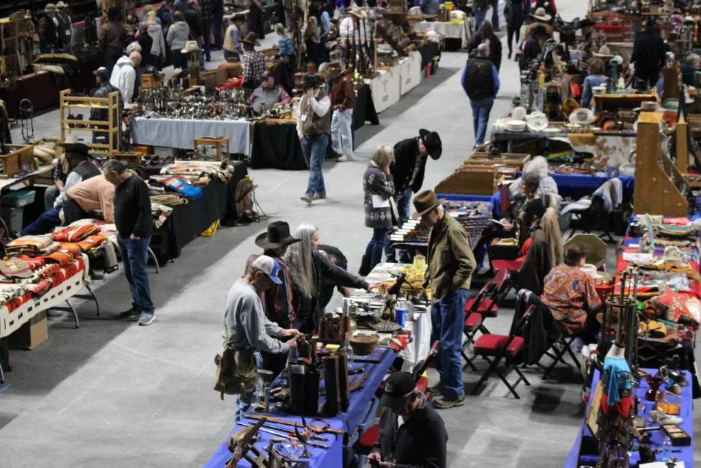 Wide aisle view of the CCG show floor with collectors browsing vendor tables
