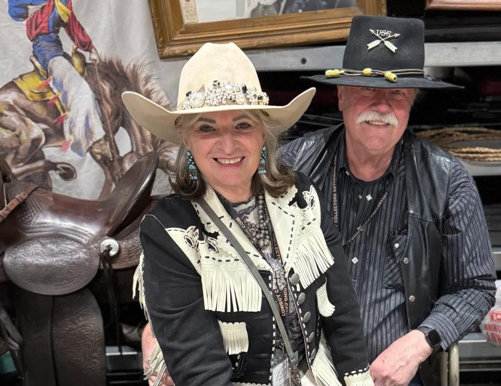 Couple in western hats and fringe jacket at CCG show
