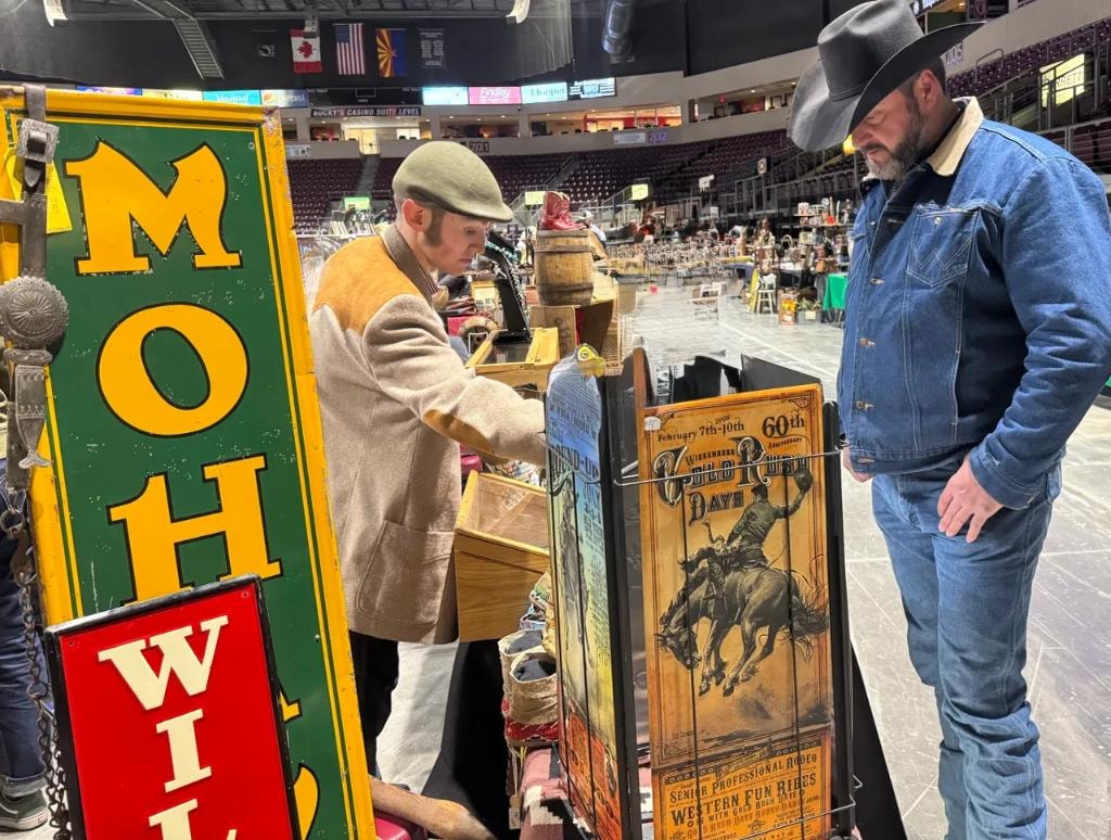 Attendees browsing vendor booths on the show floor