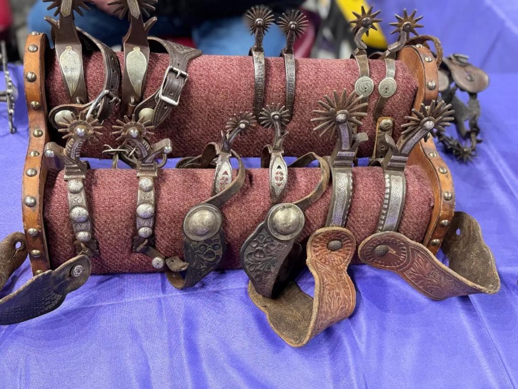 Collection of decorative western spurs and leather gear