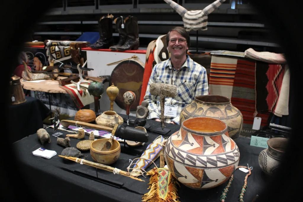 Exhibitor with Native American pottery and artifacts at CCG booth